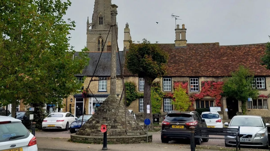 Higham Ferrers town centre with historic market buildings and local shops