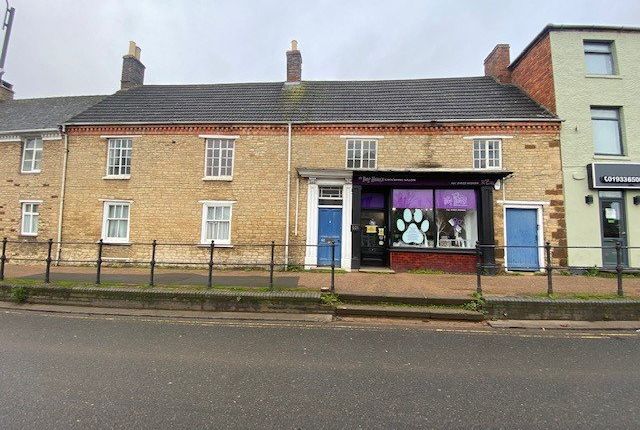 Raunds town centre with traditional shops and countryside backdrop