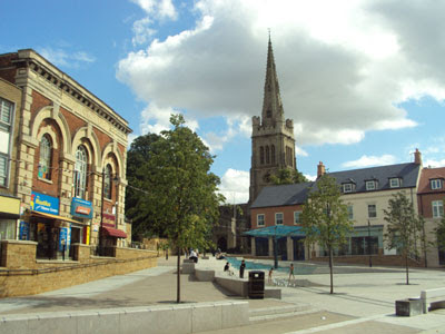 Kettering town centre with high street shops and red-brick buildings